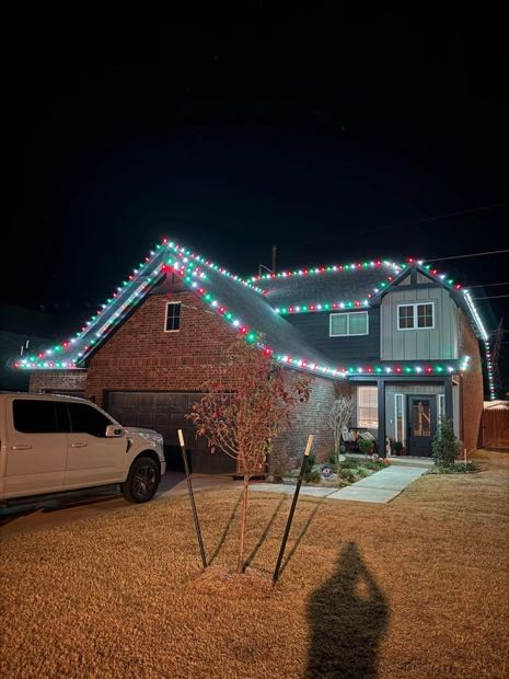 Home outlined in red and white lights with a wrapped column