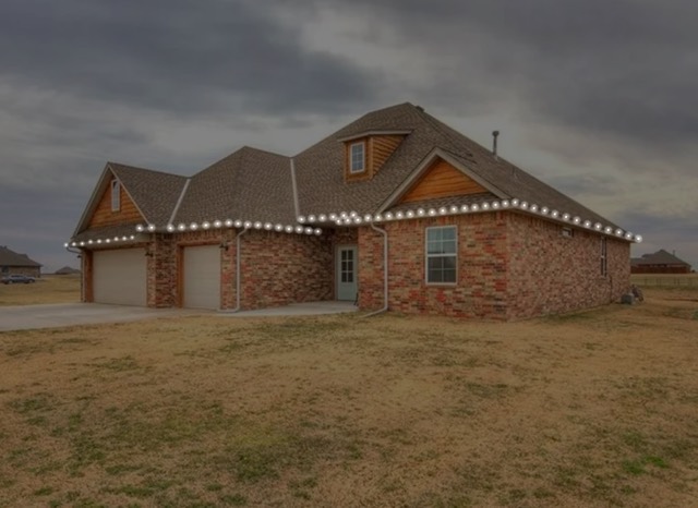 Design mockup of a brick home with warm white Christmas lights along the rooflines